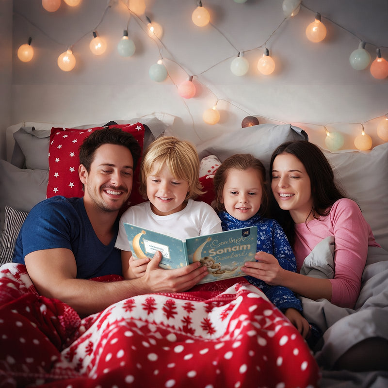 Mom, dad and two kids under a red Christmas blanket in bed, reading a personalized Elfink bedtime book with a child's name on the cover